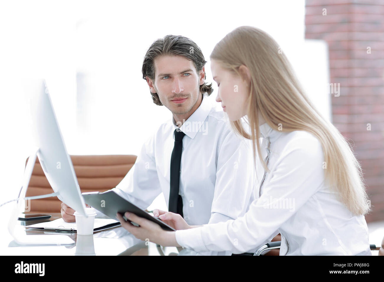 Manager and employee discussing working papers Stock Photo