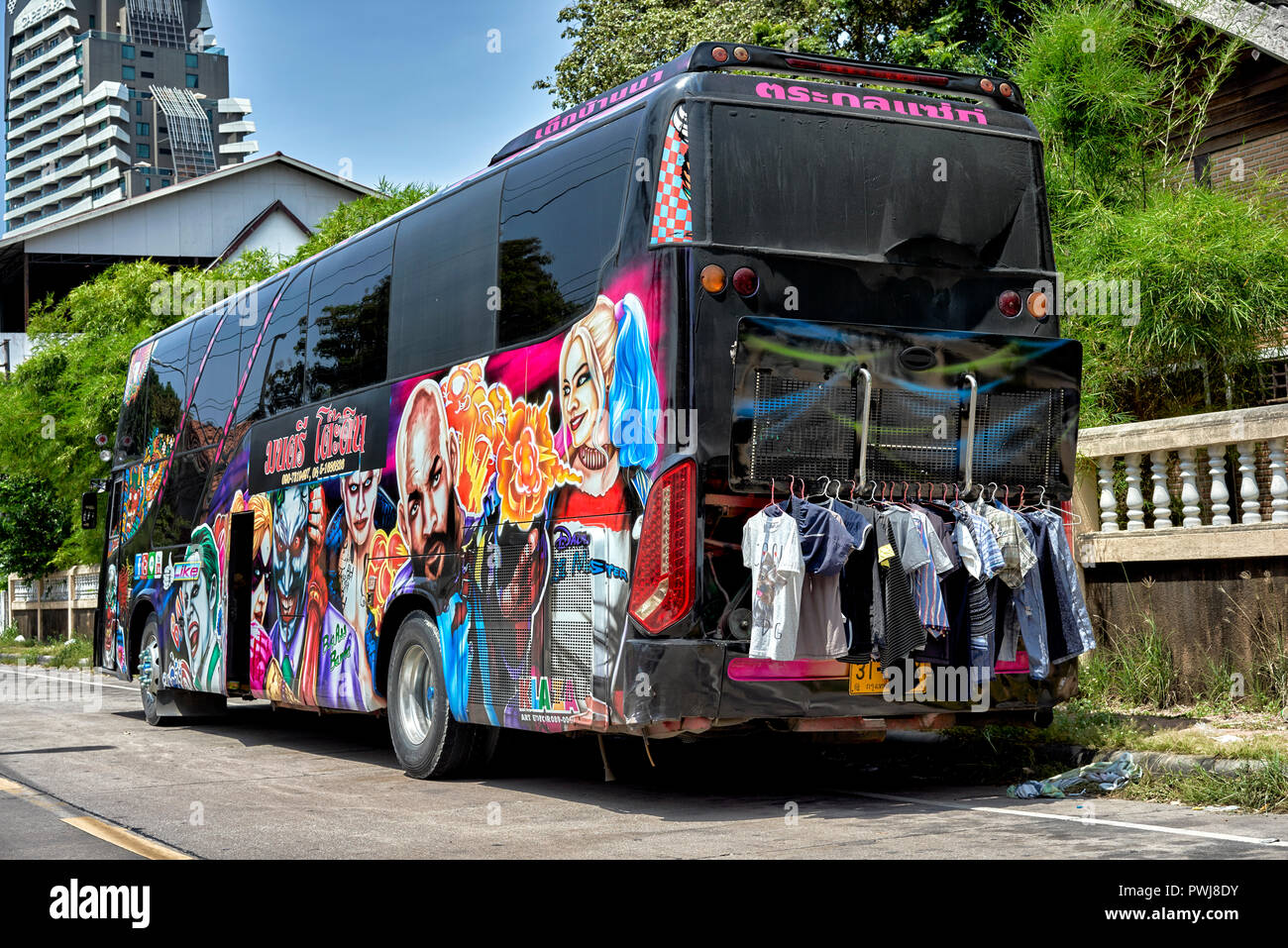 Thailand band tour bus with laundry hanging out to dry on the rear of their bus Stock Photo