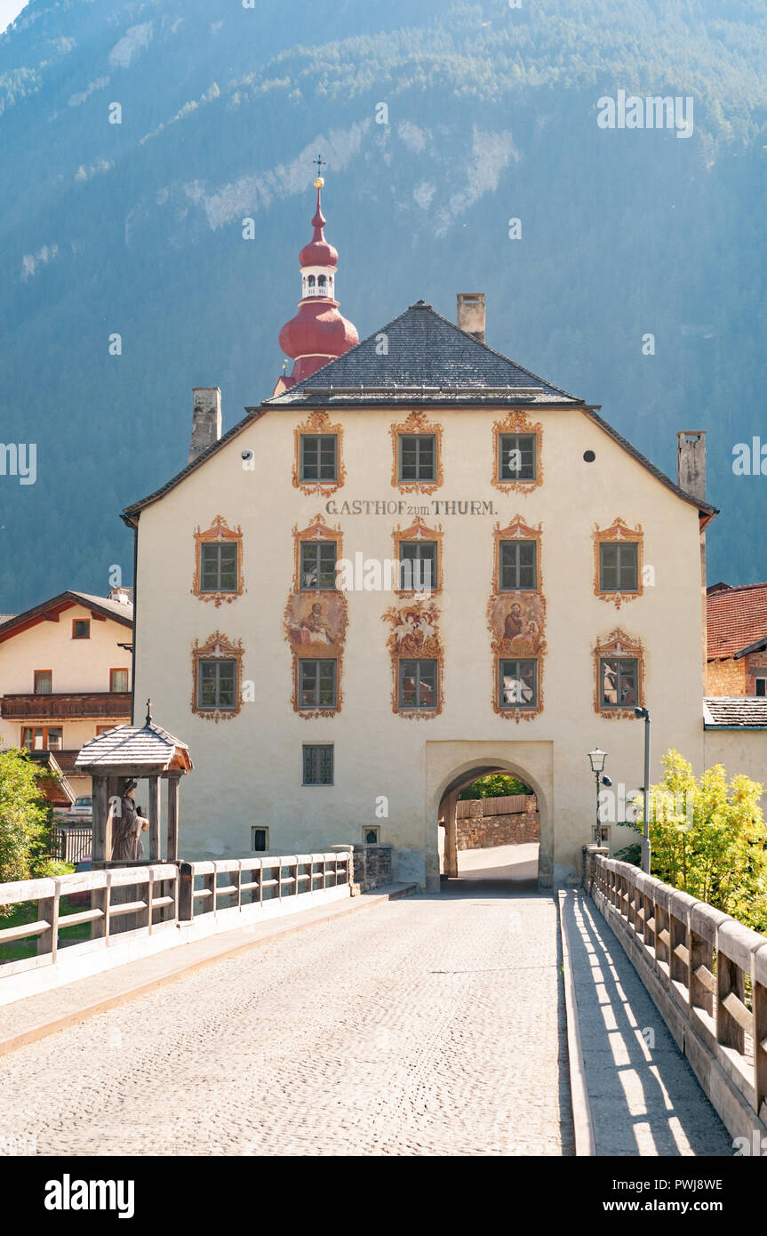 The old bridge and the tower house at Pfunds is a municipality in the district of Landeck in the Austrian state of Tyrol Stock Photo