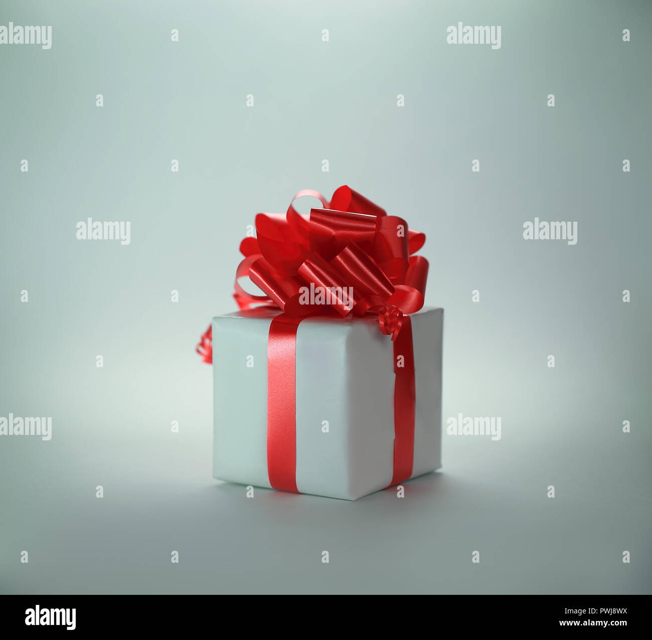 white gift box with red ribbon .isolated on white Stock Photo - Alamy