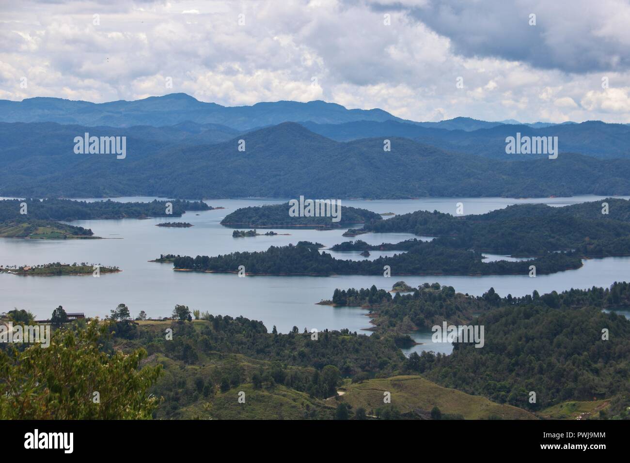 Stunning view including lakes, forests and clouds. Stock Photo