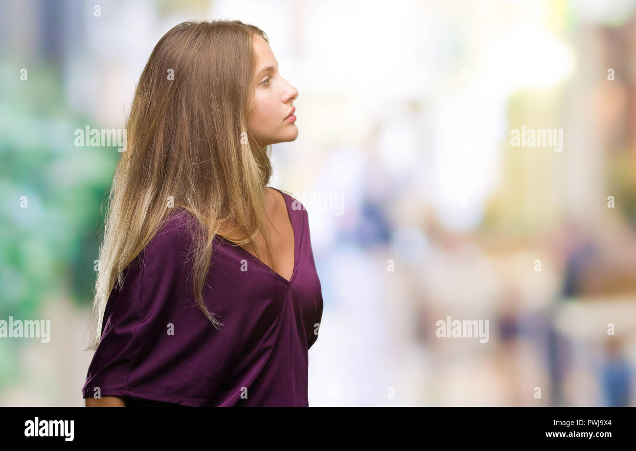 Young beautiful blonde elegant woman over isolated background looking to  side, relax profile pose with natural face with confident smile Stock Photo  - Alamy