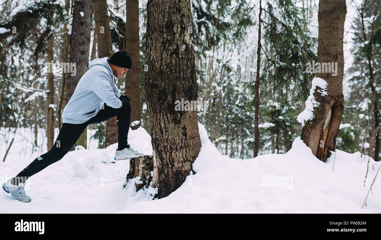 Young athlete warming up his legs before run in forest Stock Photo - Alamy