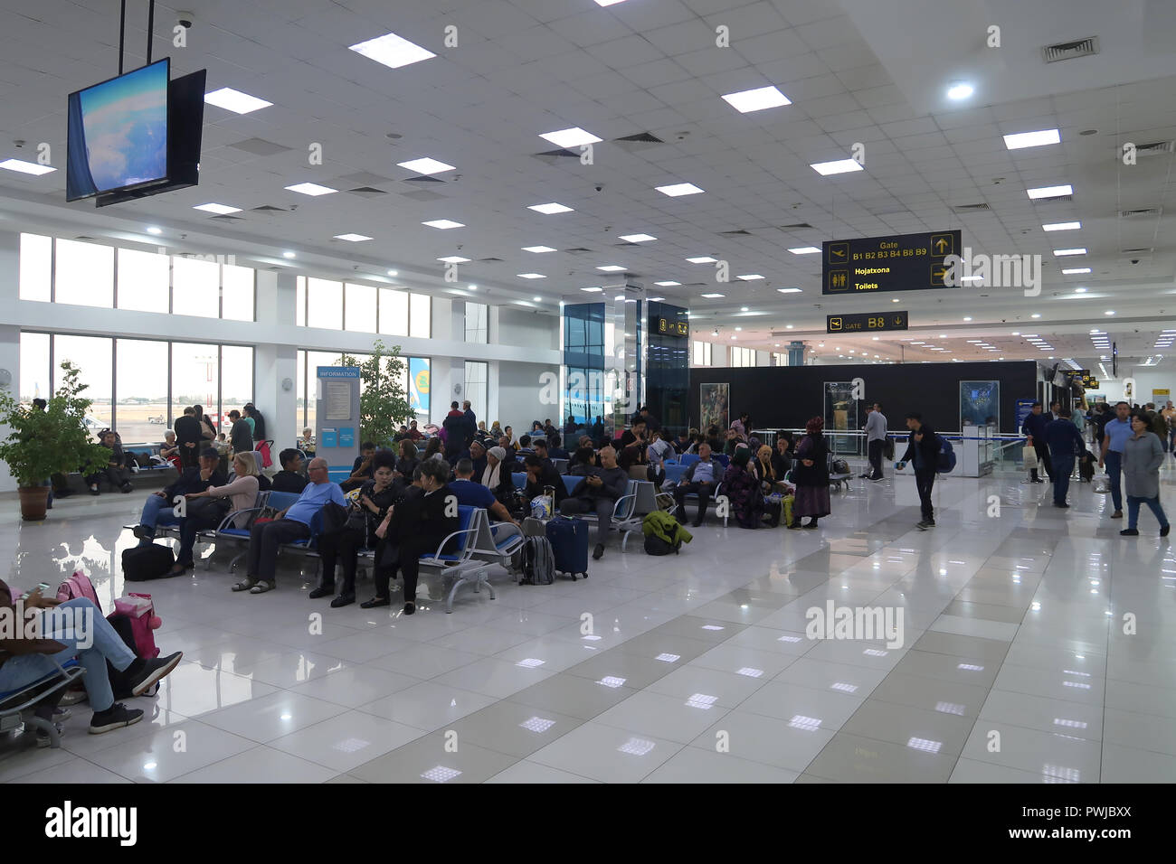 Passengers wait for their flight at the terminal of the Tashkent Yuzhny International Airport in Tashkent capital of Uzbekistan Stock Photo