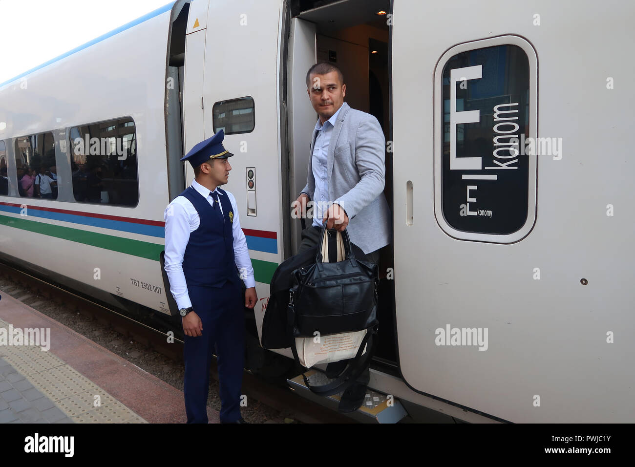 Passenger disembarks from the economy class wagon of the Afrosiyob  high-speed train which connects between