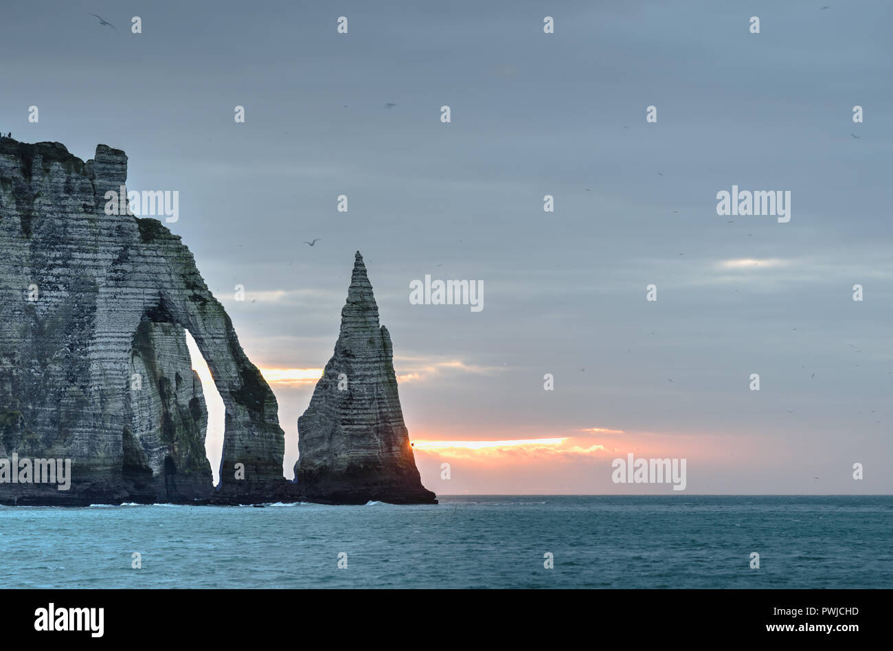 One windy and cold blue evening in Etretat, Normandy, France, famous rocks and cliffs Stock Photo