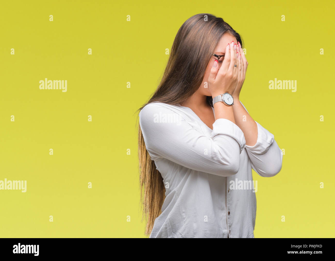 Young caucasian beautiful business woman wearing glasses over isolated background with sad expression covering face with hands while crying. Depressio Stock Photo