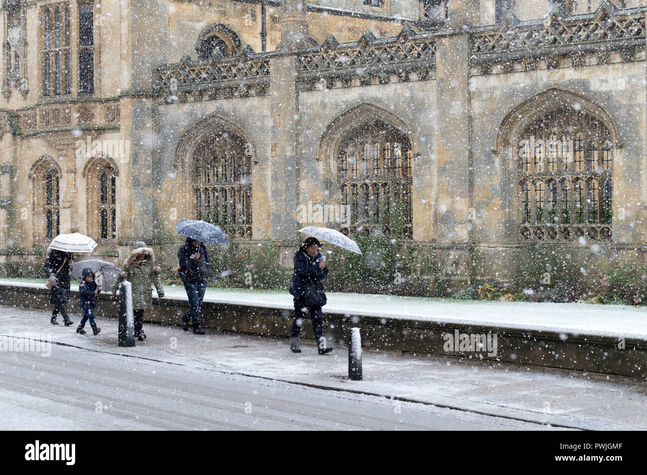 Tourists with the umbrellas in Cambridge during a snowstorm Stock Photo
