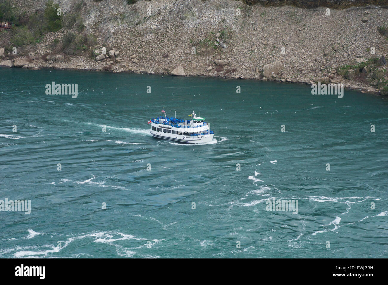 NIAGARA FALLS, ONTARIO, CANADA - MAY 21st 2018: The Maid of the Mist cruise ferry transports tourists through the mist on the wild waters at Niagara Falls Stock Photo