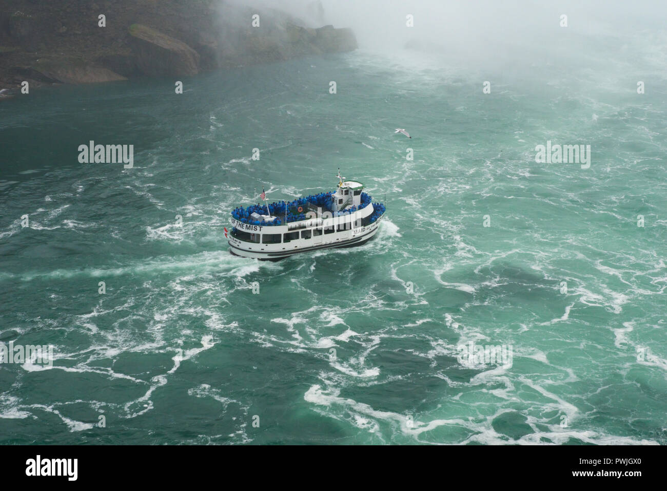 NIAGARA FALLS, ONTARIO, CANADA - MAY 21st 2018: The Maid of the Mist cruise ferry transports tourists through the mist on the wild waters at Niagara Falls Stock Photo