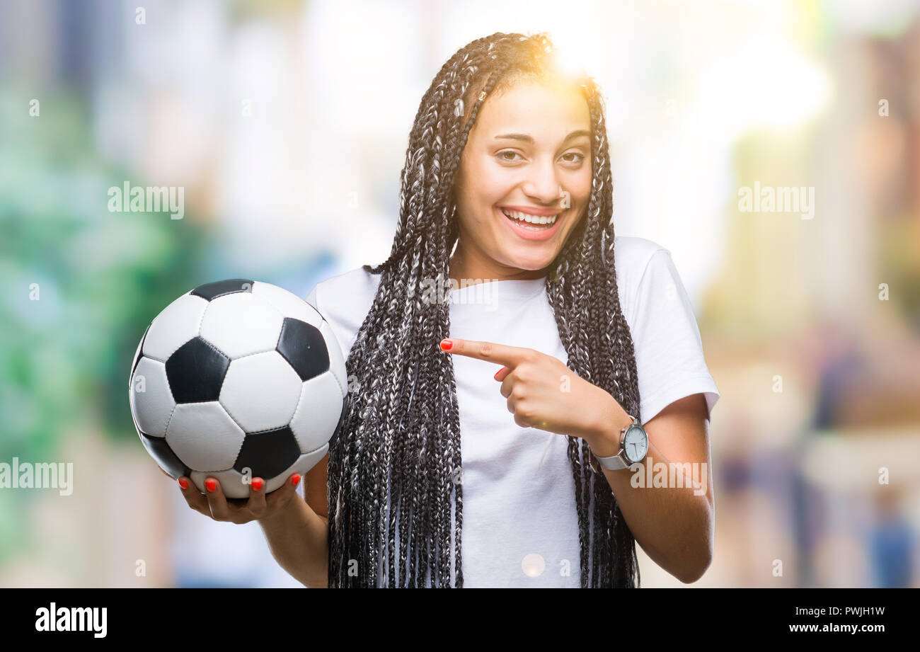 Young Braided Hair African American Girl Holding Soccer Ball Over