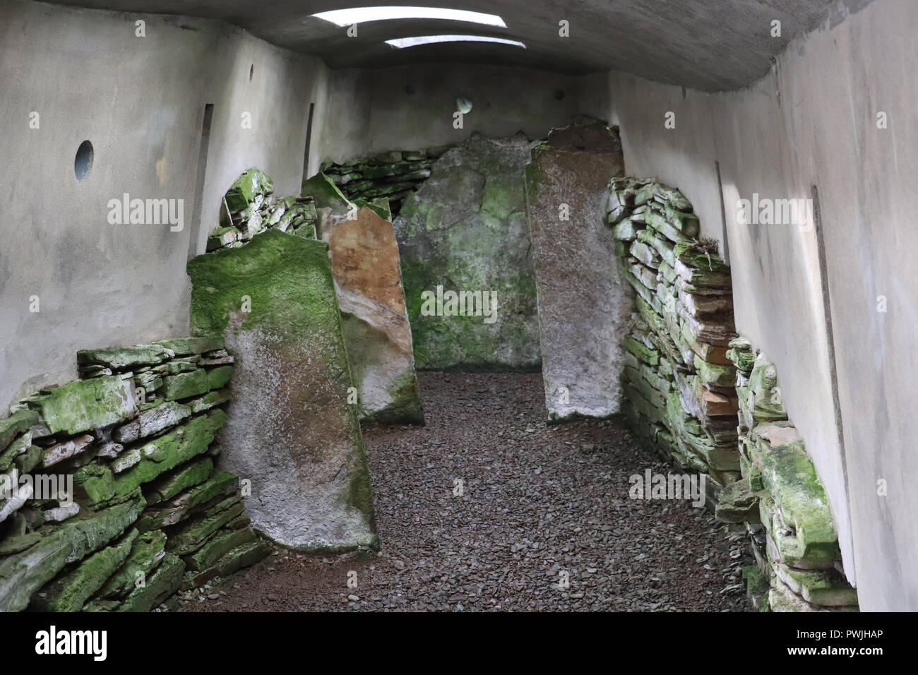 Interior of the remains of the Blackhammar Cairn, covered with a protective roof. A huge stone slab caps each end, Rousay Island, Orkney, Scotland. Stock Photo
