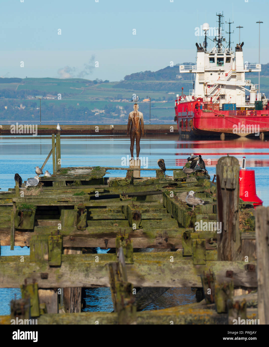 Sculpture by Antony Gormley , Sixth Statue, made from cast iron, Port of Leith, Scotland, UK