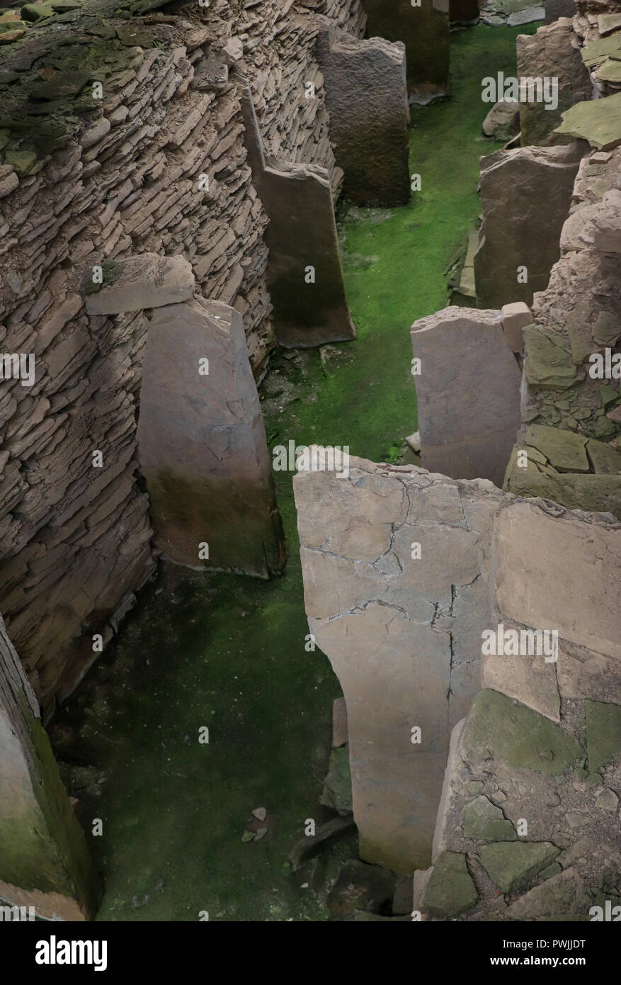 Upright flagstones create 12 stalls in the great Midhowe Stalled Cairn, on Rousay Island. Dated to 3500 BC, it is the largest in Orkney, Scotland. Stock Photo