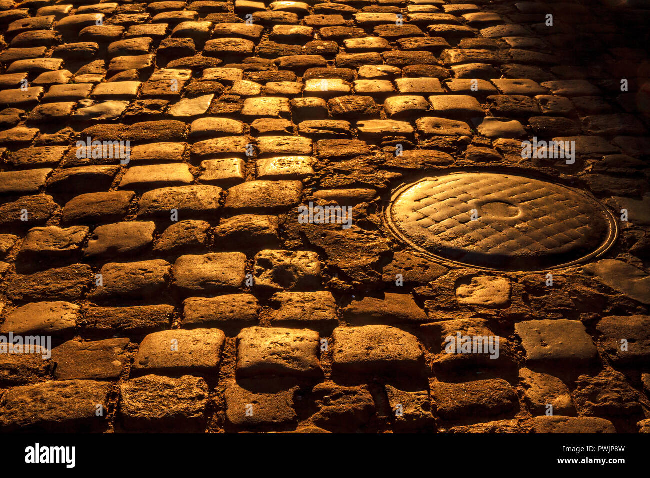 cobblestone and sewer hatch Stock Photo - Alamy