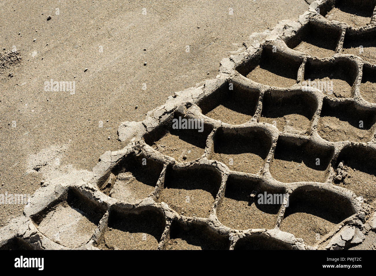 Close-up of tire track in sand Stock Photo