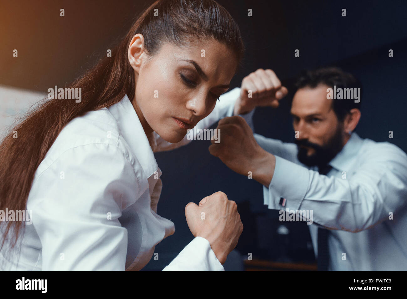 Young businessman and businesswoman compete Stock Photo