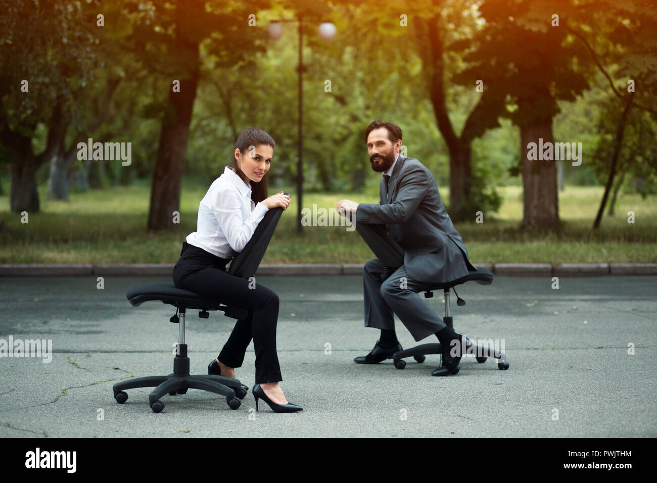 Businesspeople having racing on office chairs Stock Photo