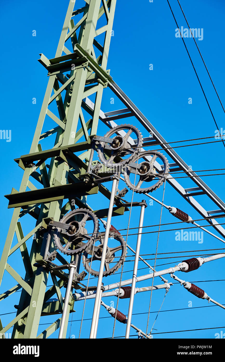 Overhead train electric traction system against the blue sky. Stock Photo