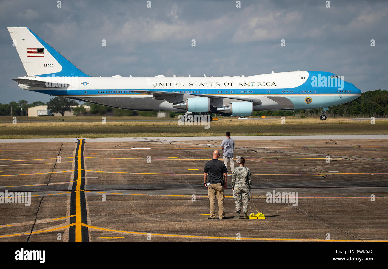 Ground crew wait on the arrival of Air Force One to taxi into place at Eglin Air Force Base, Fla., Oct. 15. President Donald J. Trump stopped at Eglin on his way to Panama City to see the devastation from Hurricane Michael. The President exited Air Force One, met with Florida and base leadership, as well as the media before departing to the east on his helicopter. (U.S. Air Force photo/Samuel King Jr.) Stock Photo