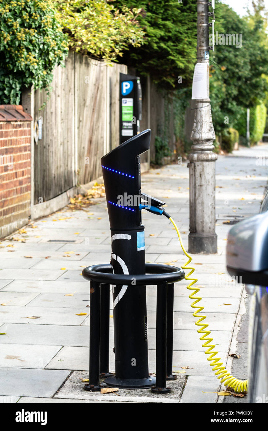Hybrid car charging at a public charging point Stock Photo Alamy