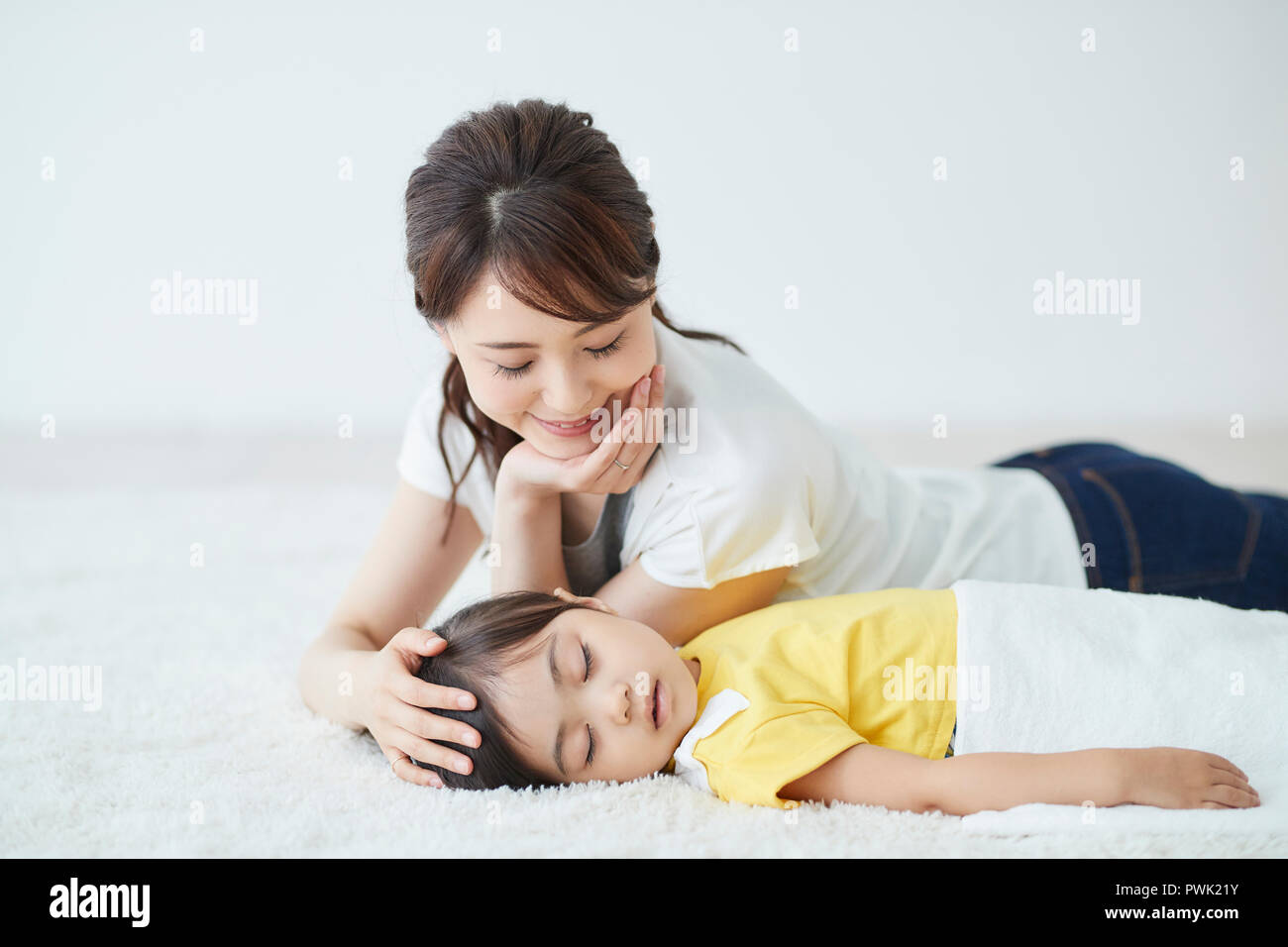 Mother watching daughter sleep hires stock photography and images Alamy