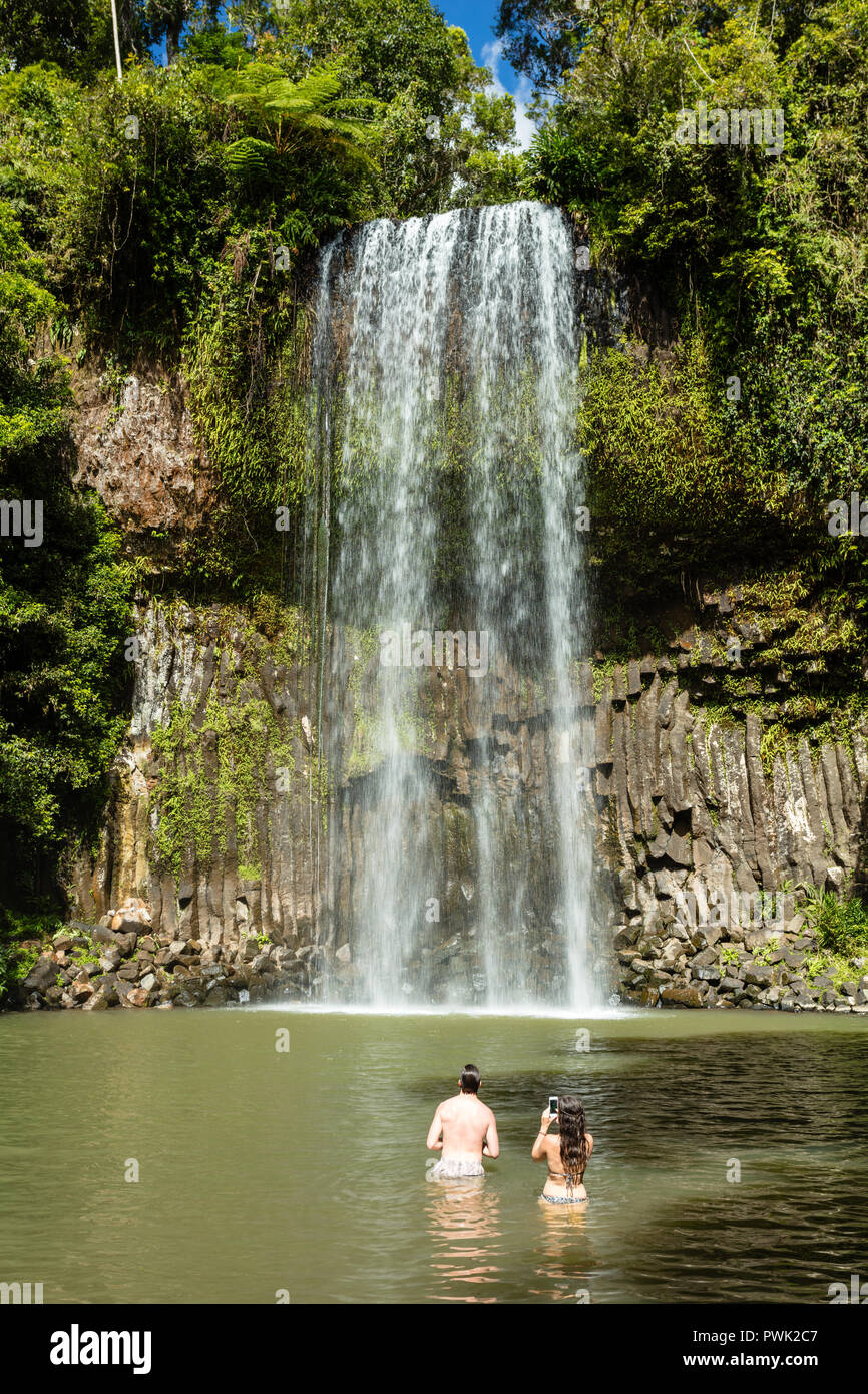 Millaa Millaa, Queensland, Australia. People enjoying Millaa Millaa Falls near Millaa Millaa on the Atherton Tablelands in Far North Queeensland Stock Photo
