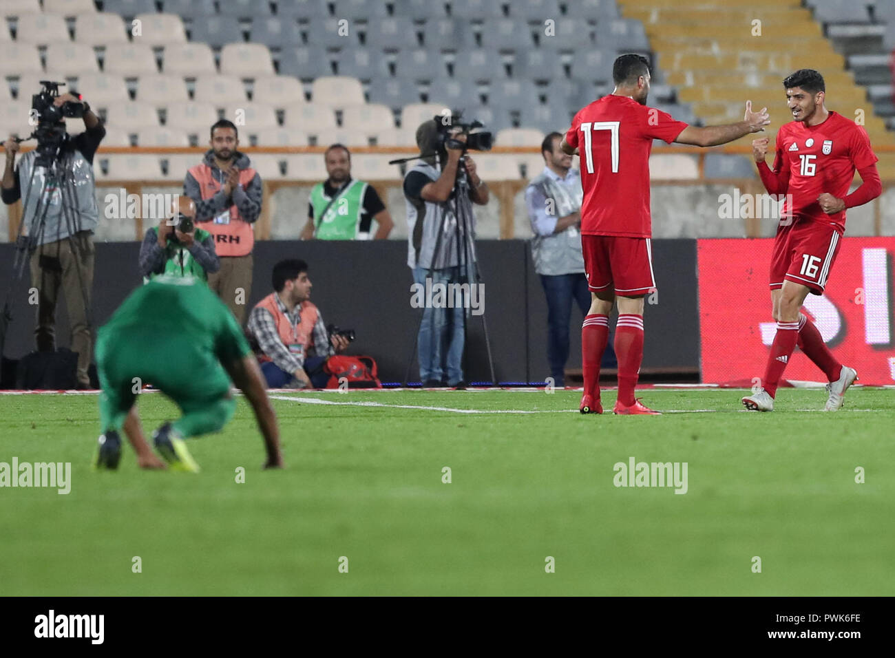 Tehran, Iran. 16th Oct, 2018. Iran's Mehdi Torabi (R) celebrates scoring his side's second goal with teammate Mehdi Taremi during an International Friendly soccer match between Iran and Bolivia at the Azadi Stadium. The Iranian authorities have allowed women to attend the match after a request from the Football Federation of the Islamic Republic of Iran. Credit: Saeid Zareian/dpa/Alamy Live News Stock Photo