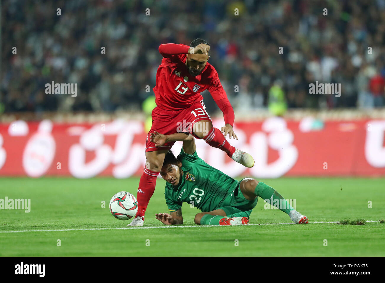 Tehran, Iran. 16th Oct, 2018. Iran's Saman Ghoddos and Bolivia's Rudy Cardozo battle for the ball during an International Friendly soccer match between Iran and Bolivia at the Azadi Stadium. The Iranian authorities have allowed women to attend the match after a request from the Football Federation of the Islamic Republic of Iran. Credit: Saeid Zareian/dpa/Alamy Live News Stock Photo