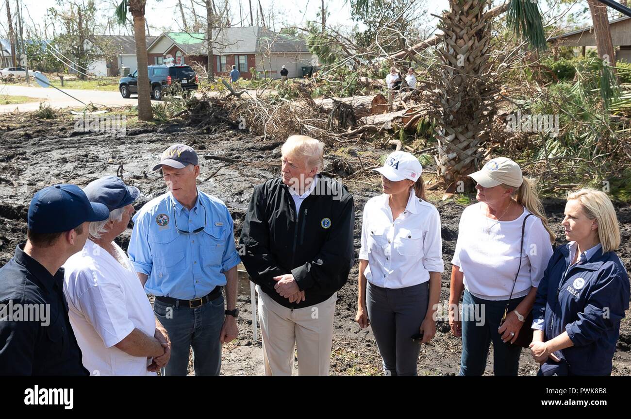 Panama City, Florida, USA. 15th Oct 2018. U.S President Donald Trump speaks to a resident during a tour of damage in the aftermath of Hurricane Michael October 15, 2018 in Lynn Haven, Florida. Standing with the president from left to right are: FEMA Administrator Brock Long, local resident, Florida Gov. Rick Scott, President Donald Trump, First Lady Melania Trump, First Lady of Florida Ann Scott and Homeland Security Secretary Kirstjen Nielsen. Credit: Planetpix/Alamy Live News Stock Photo