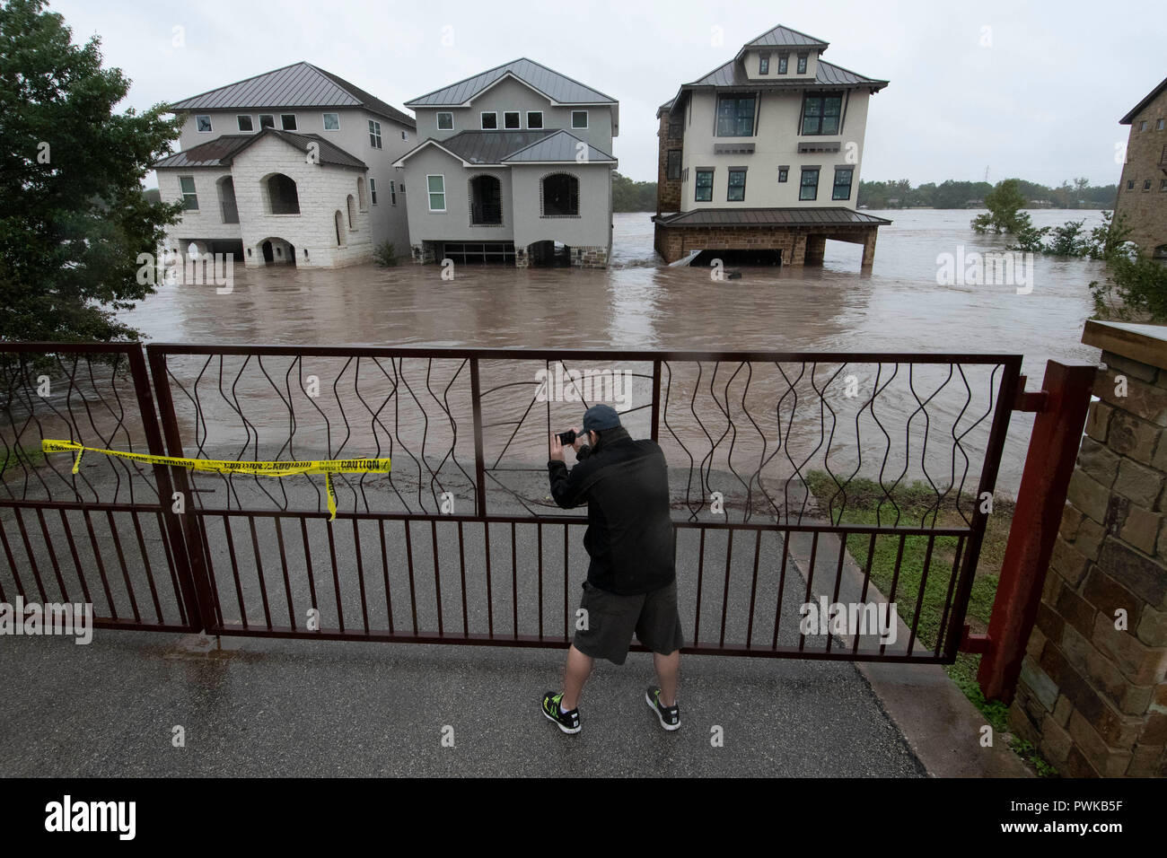 Heavy rains in the Texas Hill Country cause flooding on Lake LBJ, with mud- and debris-filled water inundating lakefront homes Stock Photo