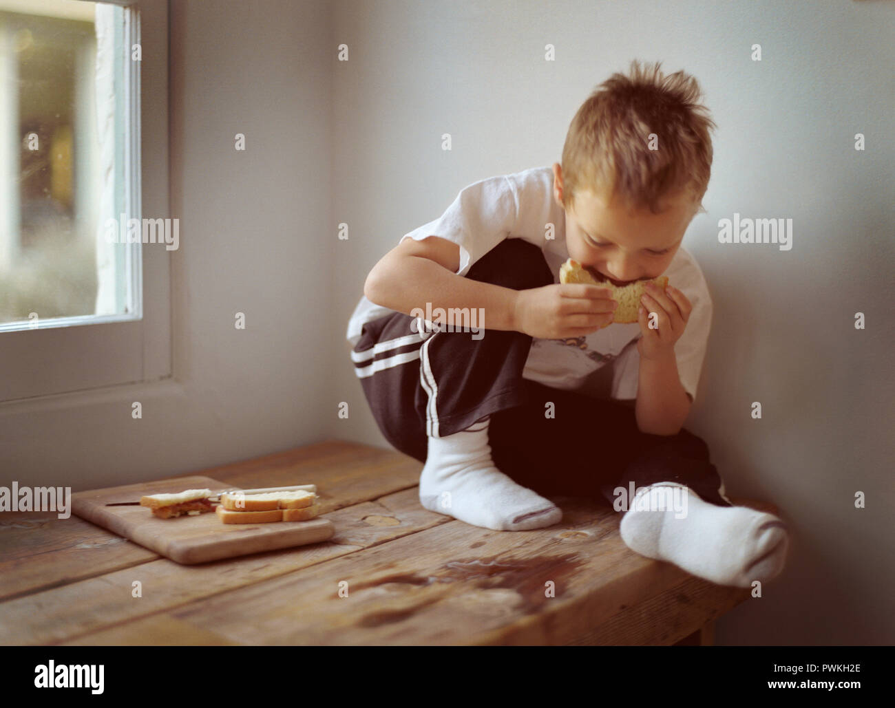 Boy eating a PB&J sandwich Stock Photo - Alamy