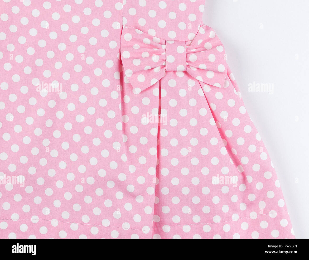 Part of pink dress with polka dot pattern background with fold Stock Photo