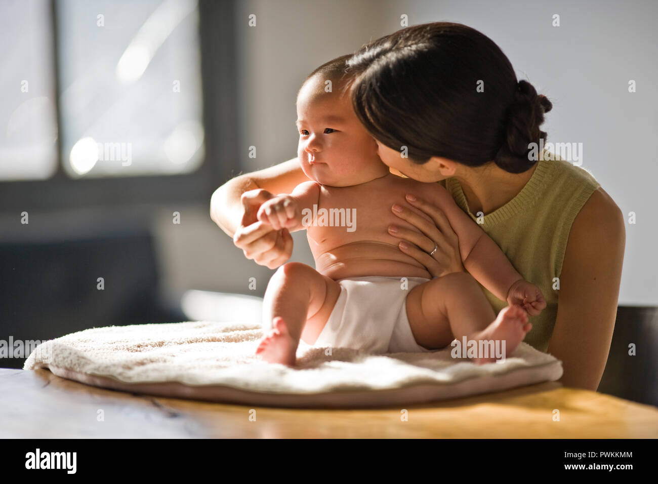 Young woman holding her baby. Stock Photo