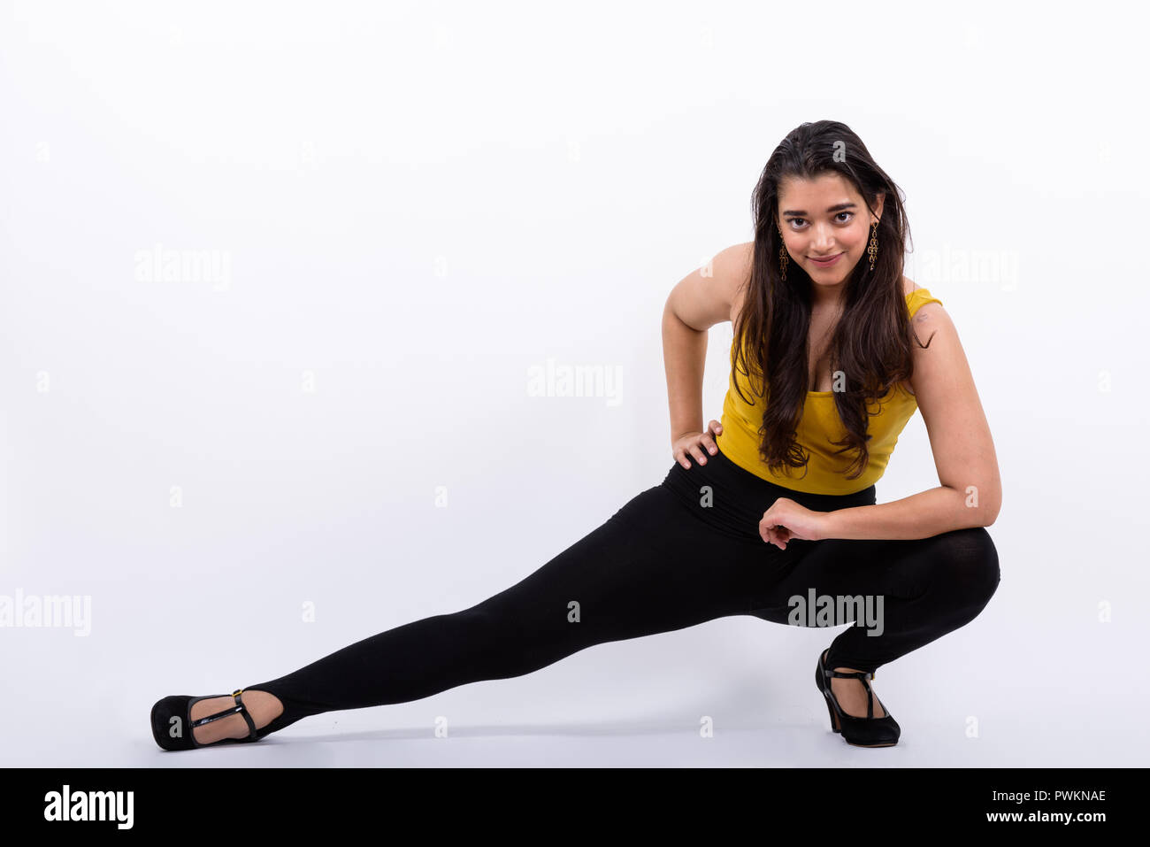 Full body shot of young beautiful Indian woman posing down on th Stock Photo