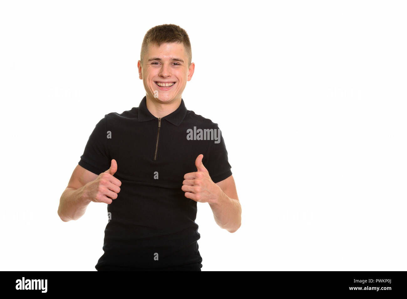 Young happy Caucasian man smiling and giving thumbs up Stock Photo