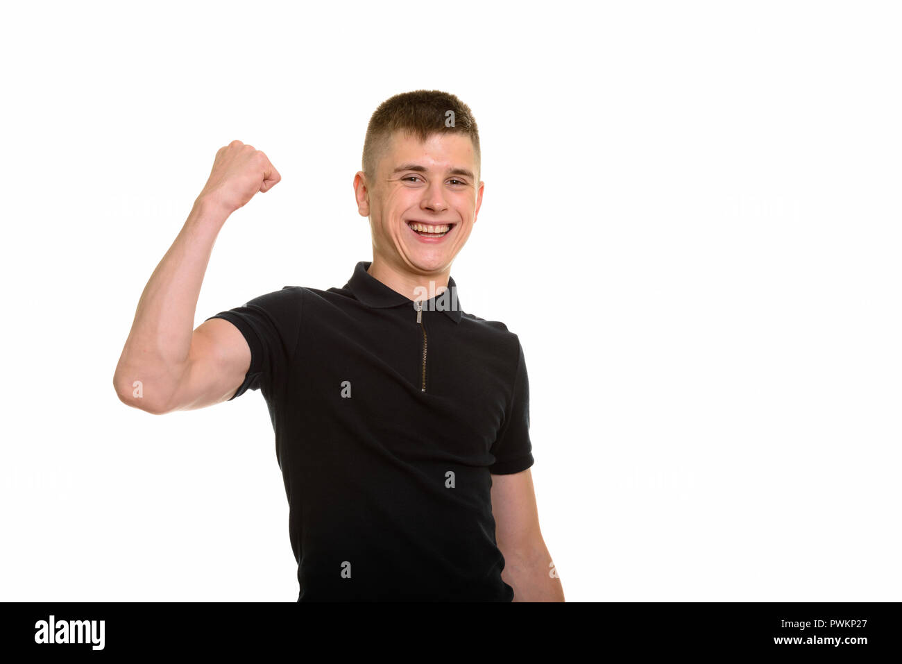 Young happy Caucasian man smiling and flexing arm Stock Photo