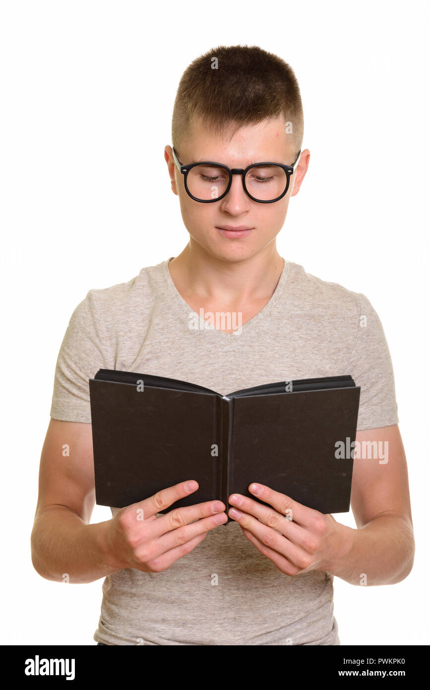 Young serious Caucasian student man reading book Stock Photo