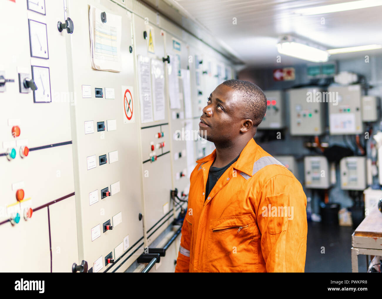 Marine engineer officer working in engine room Stock Photo