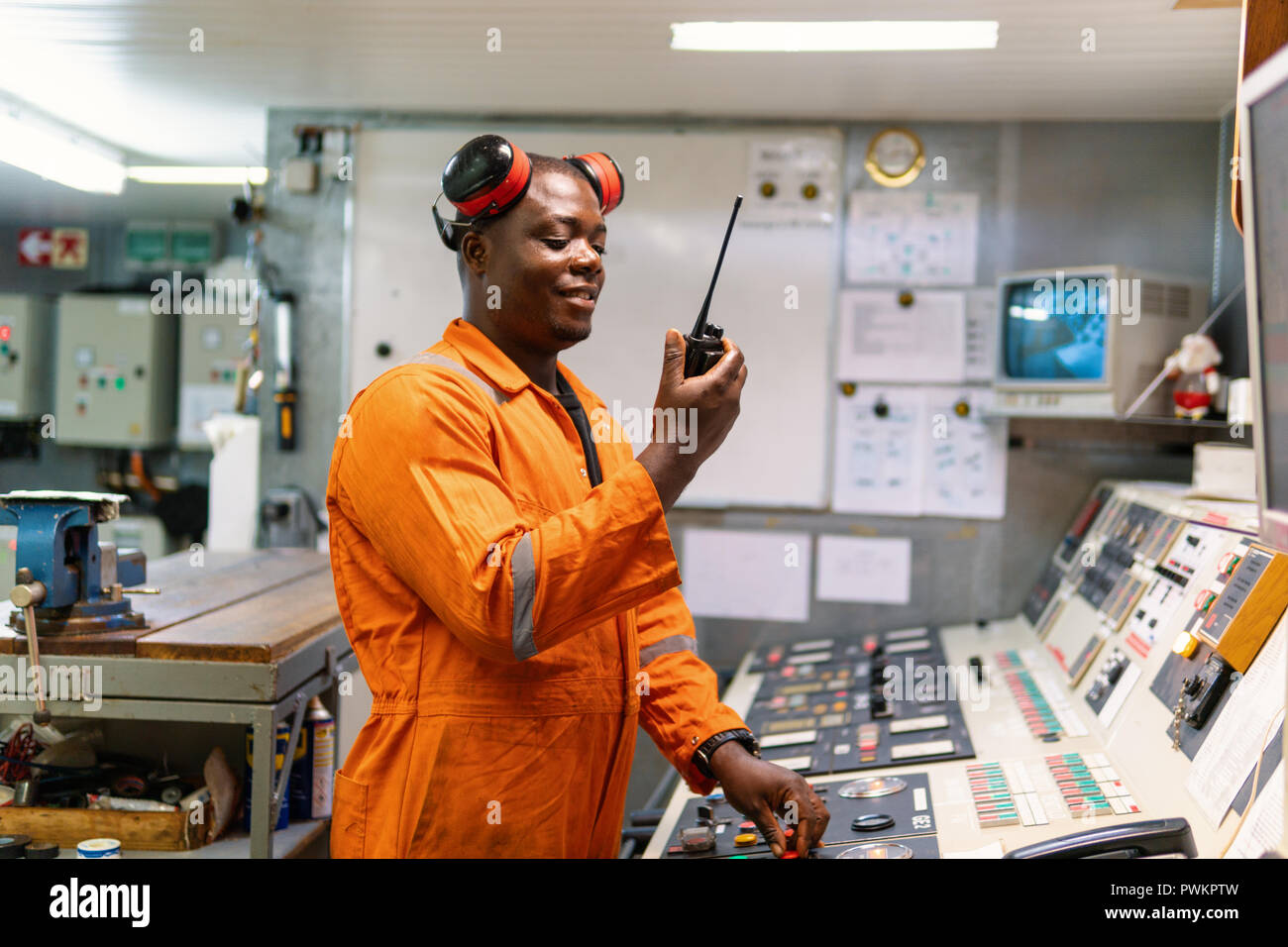 Marine engineer officer working in engine room Stock Photo Alamy
