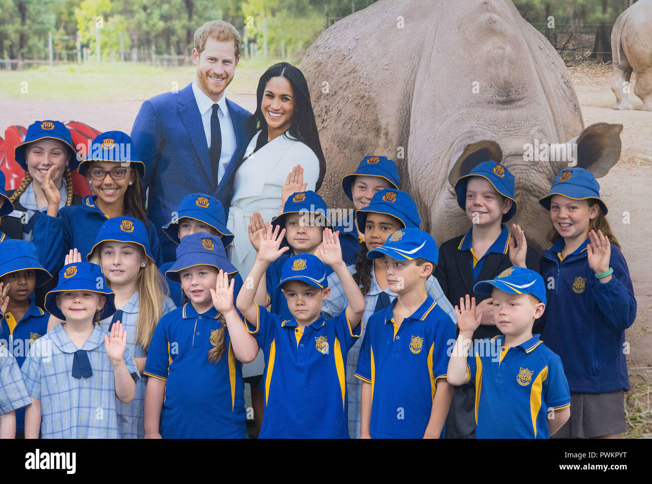 Pupils from South Dubbo Public School pose for a photo with a picture of the Duke and Duchess of Sussex as they await their arrival at Dubbo City Regional Airport, in Dubbo, New South Wales, on the second day of the royal couple's visit to Australia. Stock Photo