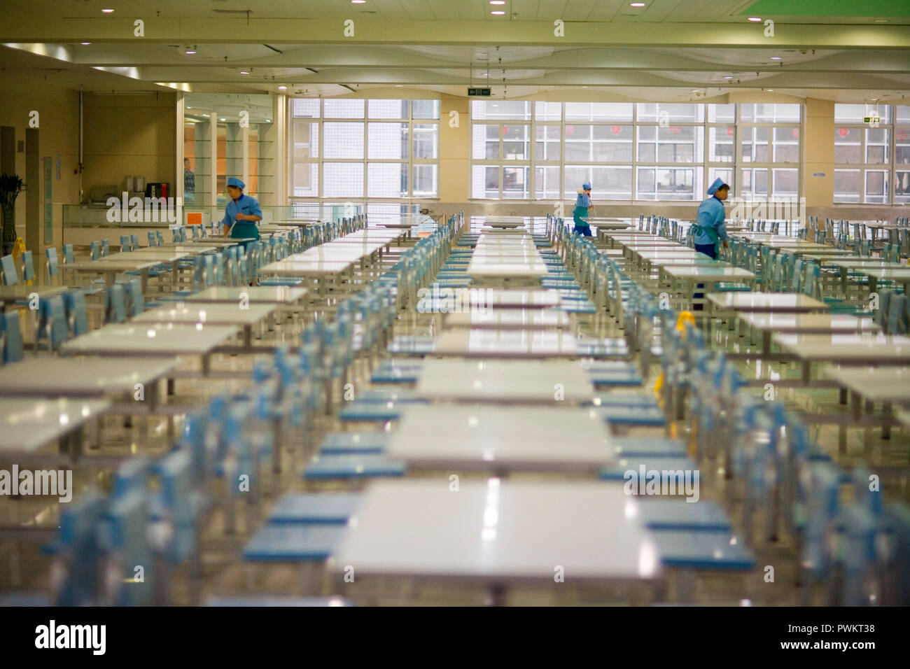 Cleaners mopping in a lunch room. Stock Photo