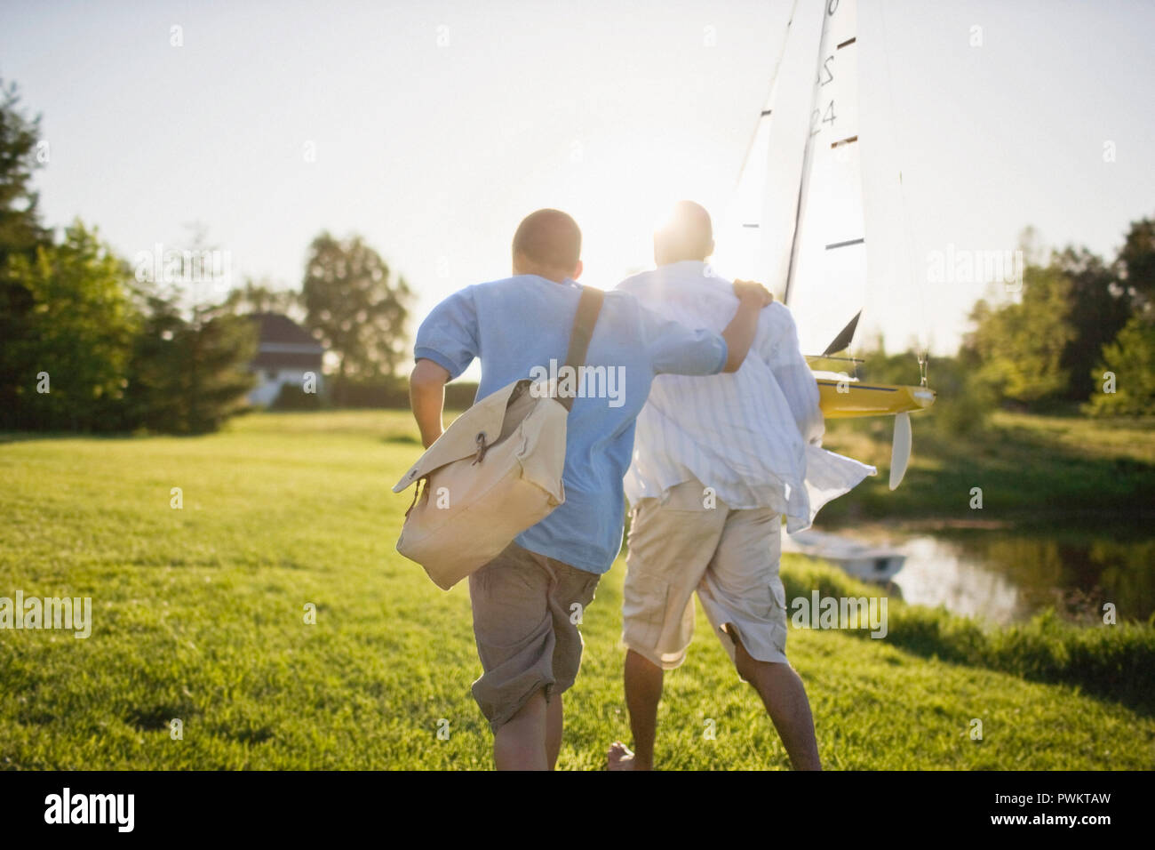 Father and son with a toy sailboat Stock Photo
