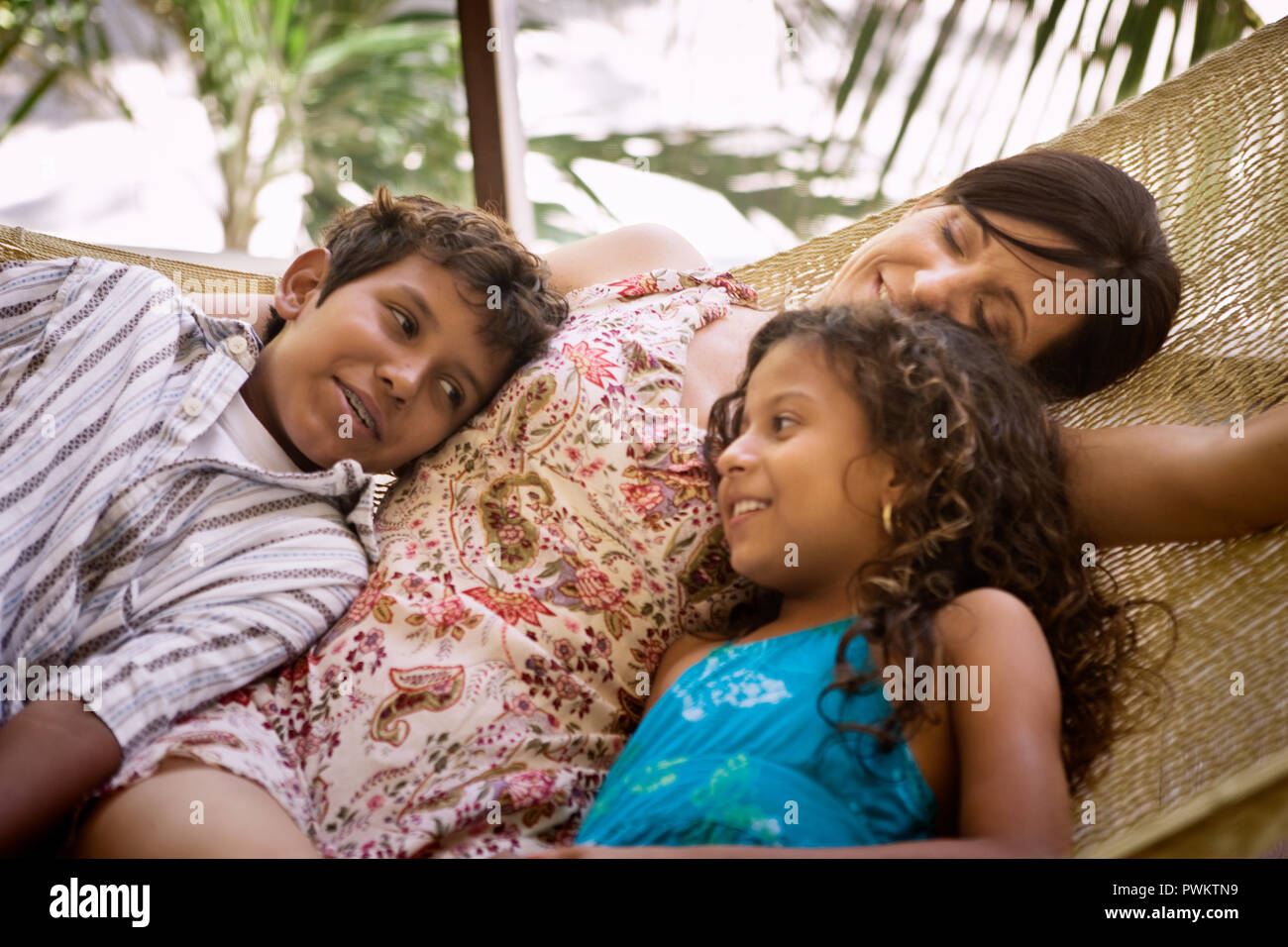 Family lying on hammock Stock Photo