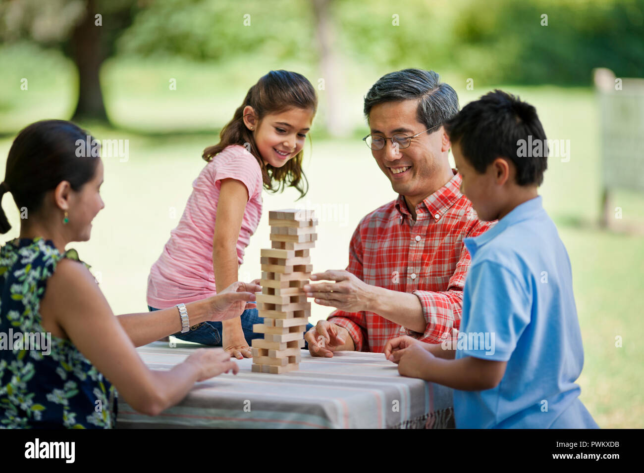 Happy family playing a game in the park Stock Photo - Alamy