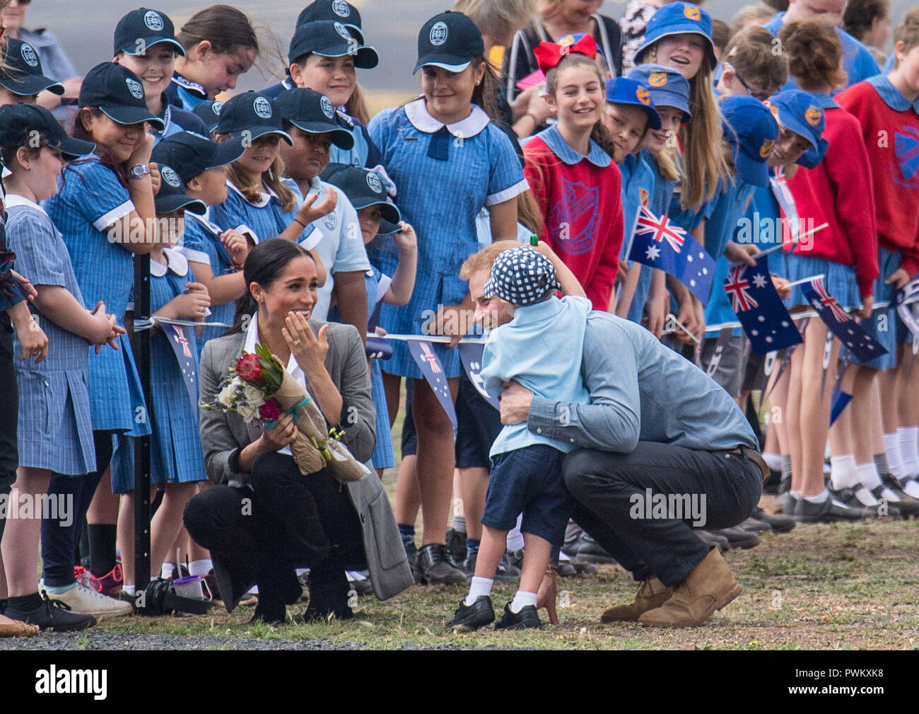 PICTURE RE-TRANSMITTED WITH ADDITIONAL CAPTION INFORMATION The Duke of Sussex hugs Luke Vincent, 5, as he and the Duchess of Sussex arrive at Dubbo City Regional Airport, in Dubbo, New South Wales, on the second day of the royal couple's visit to Australia. Stock Photo