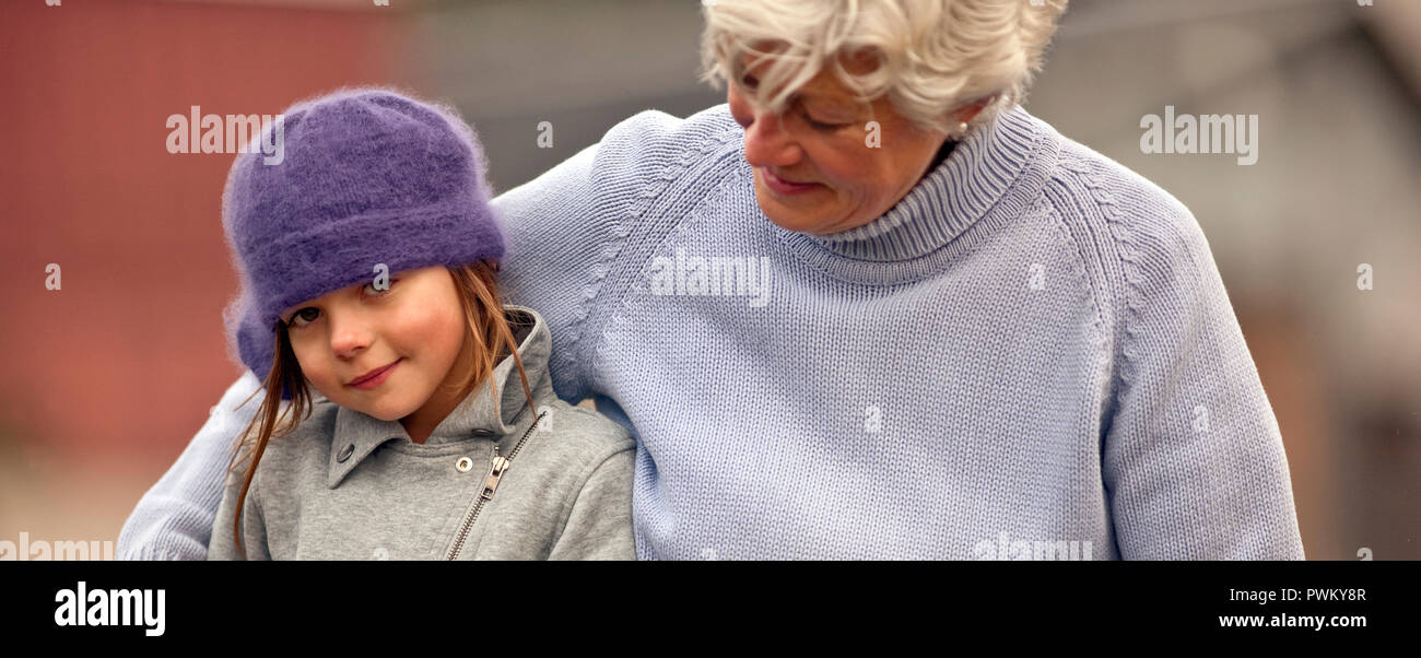 Portrait of young girl and her grandmother. Stock Photo
