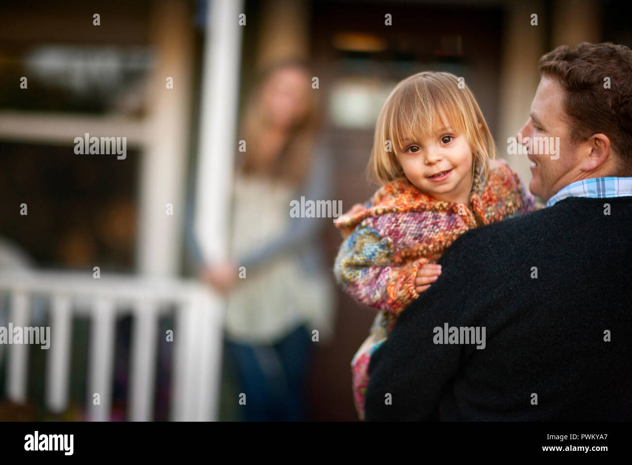 Portrait of baby girl in her father's arms. Stock Photo