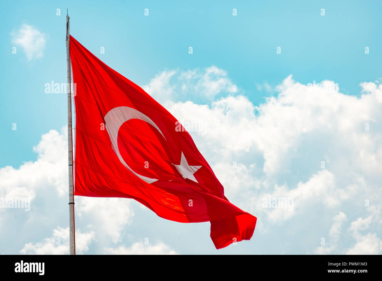 Metal pole with waving banner. Red flag with crescent moon and star, blue sky with clouds background. Rippled texture. National flag of Turkey. Pop Stock Photo - Alamy