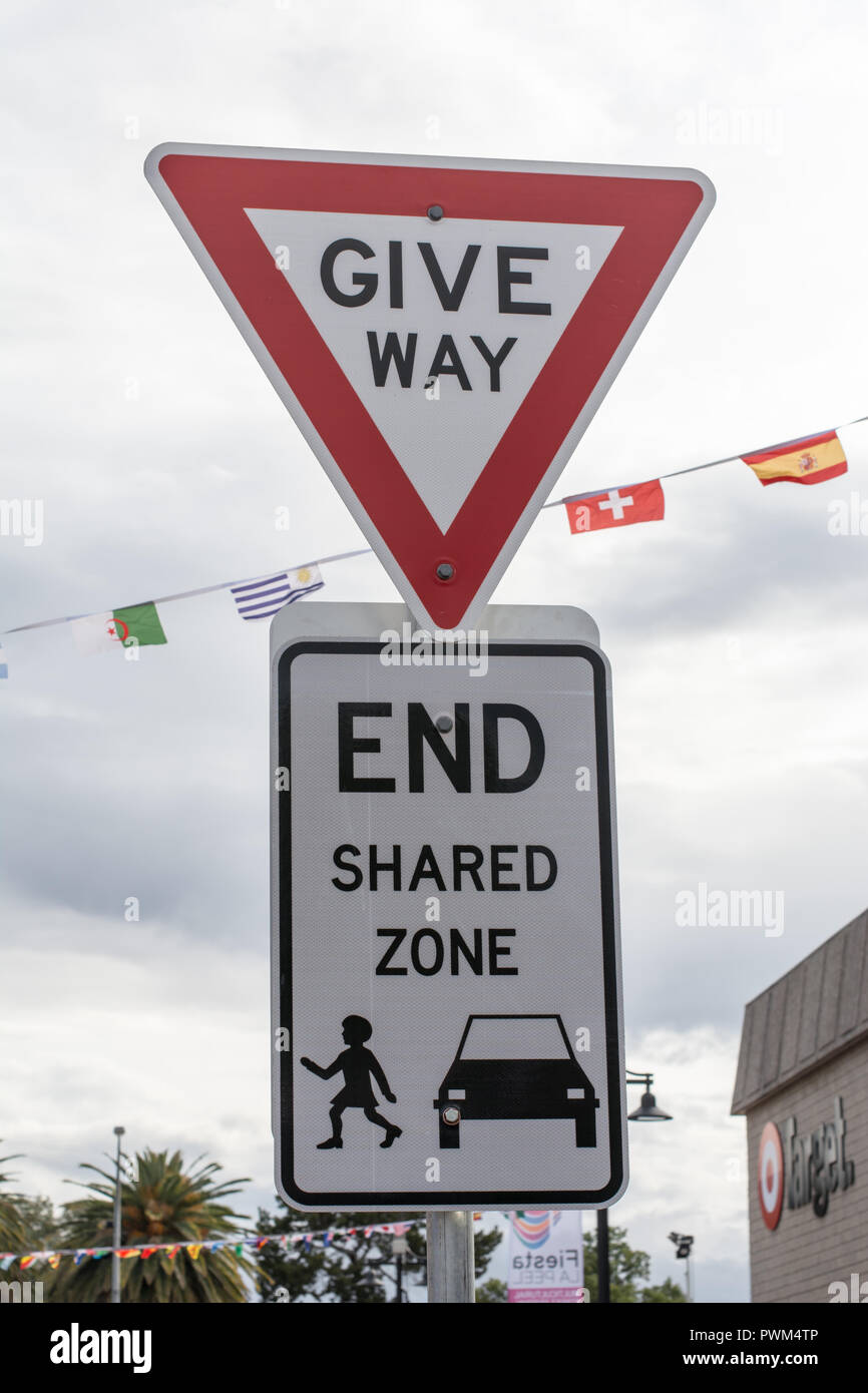Give Way traffic sign at end of shared pedestrian and cars zone. Stock Photo